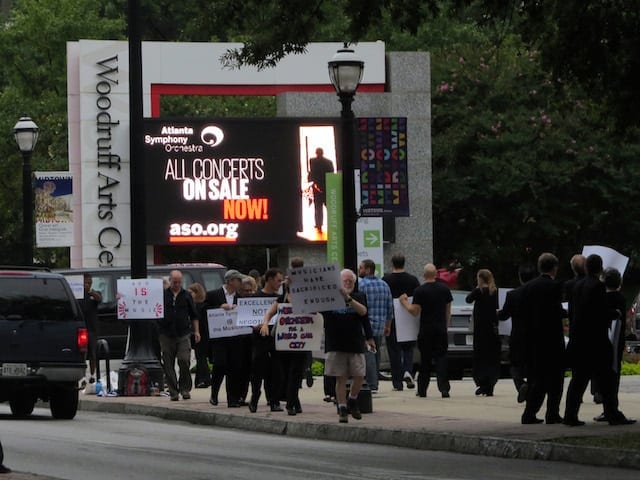 Locked out ASO musicians picket in front of a sign advertising shows that may not take place. (Photo by Mark Gresham)
