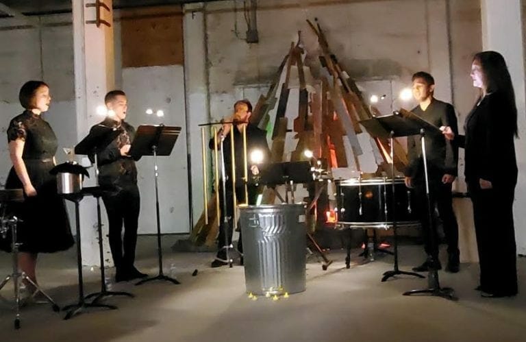 The choral group Kinnara performs in a warehouse space at MINT gallery.